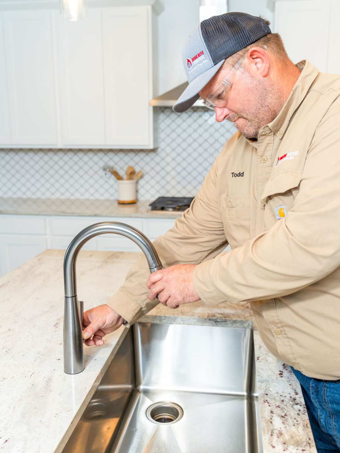 Done Rite Services plumber installing a kitchen faucet in Tucson